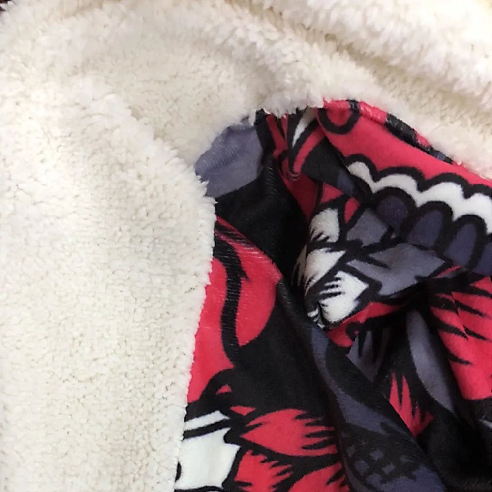 Round coral fleece burrito blanket with food print, shown in a folded pile.