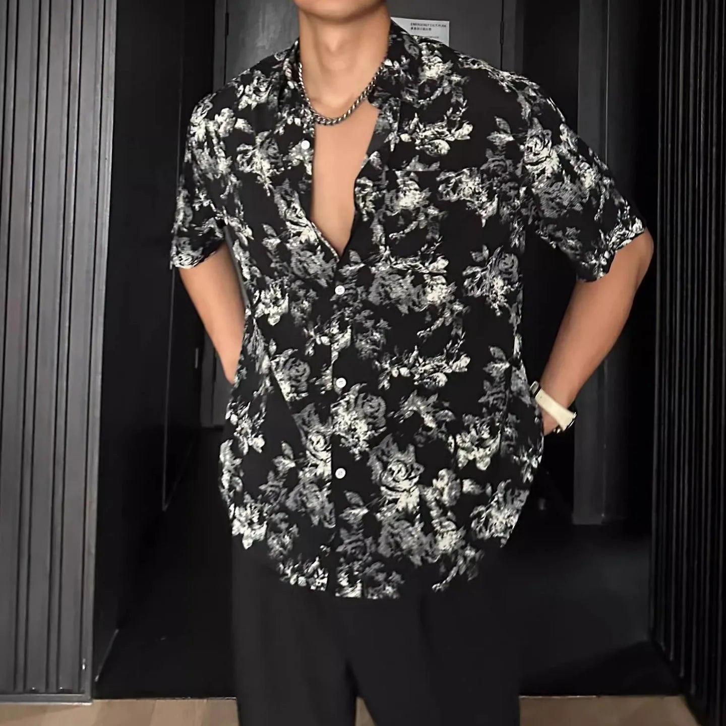 White loose-fit short sleeve casual shirt with a floral print and an open cardigan style front.
