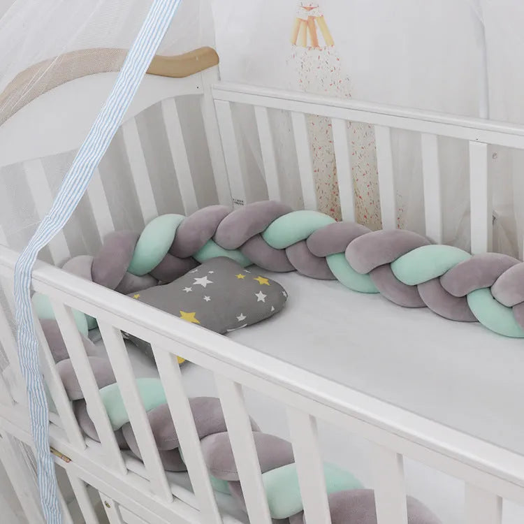 Baby crib bumper protector in spandex velvet, bent to show flexible shape, against a crib rail.