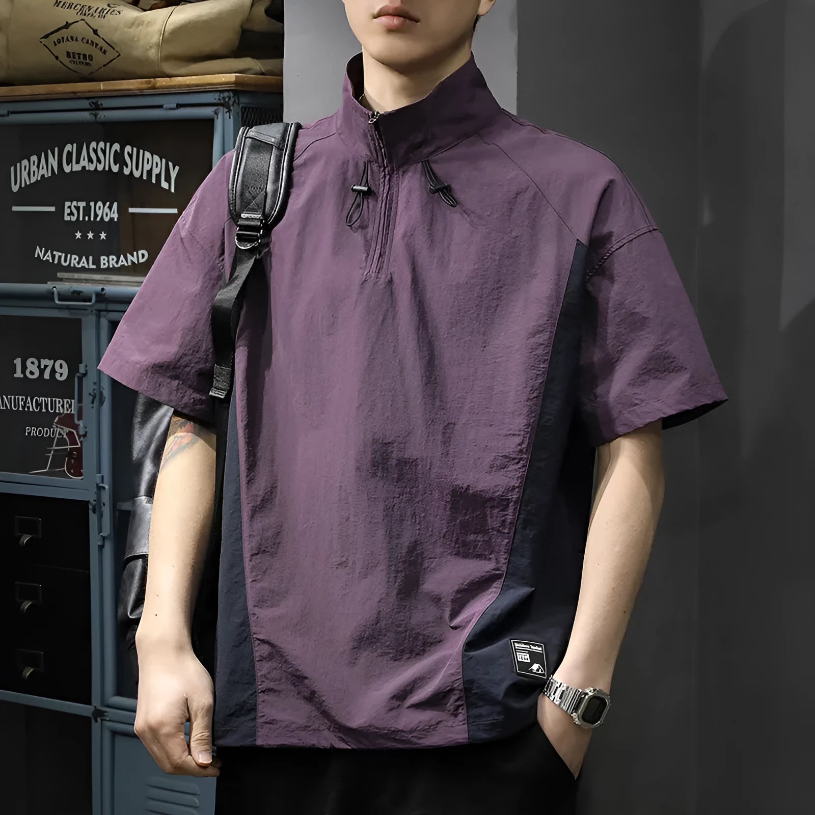 Man modelling a brown half-zip stand collar casual shirt with short sleeves.