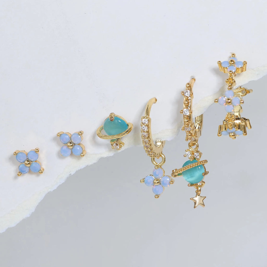 Gold and silver flower shaped stud earrings with a central zircon stone, showing front and back.
