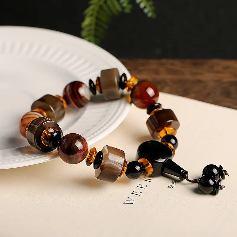 Old agate bracelet with A13 sardonyx bead, white agate spacers, and red agate barrel bead in geometric ethnic design