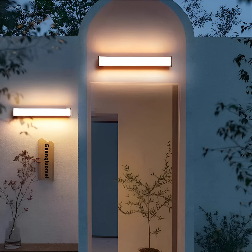 Modern outdoor wall lamp mounted on an exterior wall, showcasing its simple design.