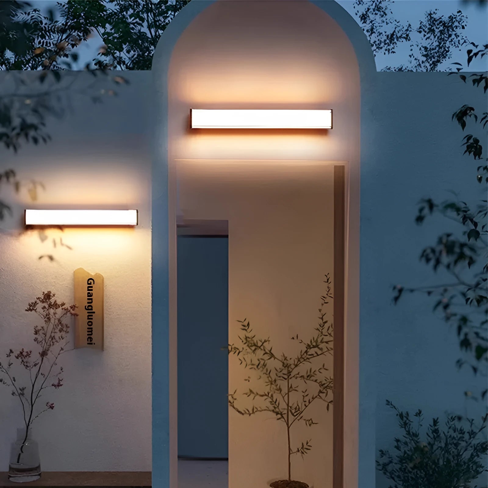 Modern outdoor wall lamp mounted on an exterior wall, showcasing its simple design.
