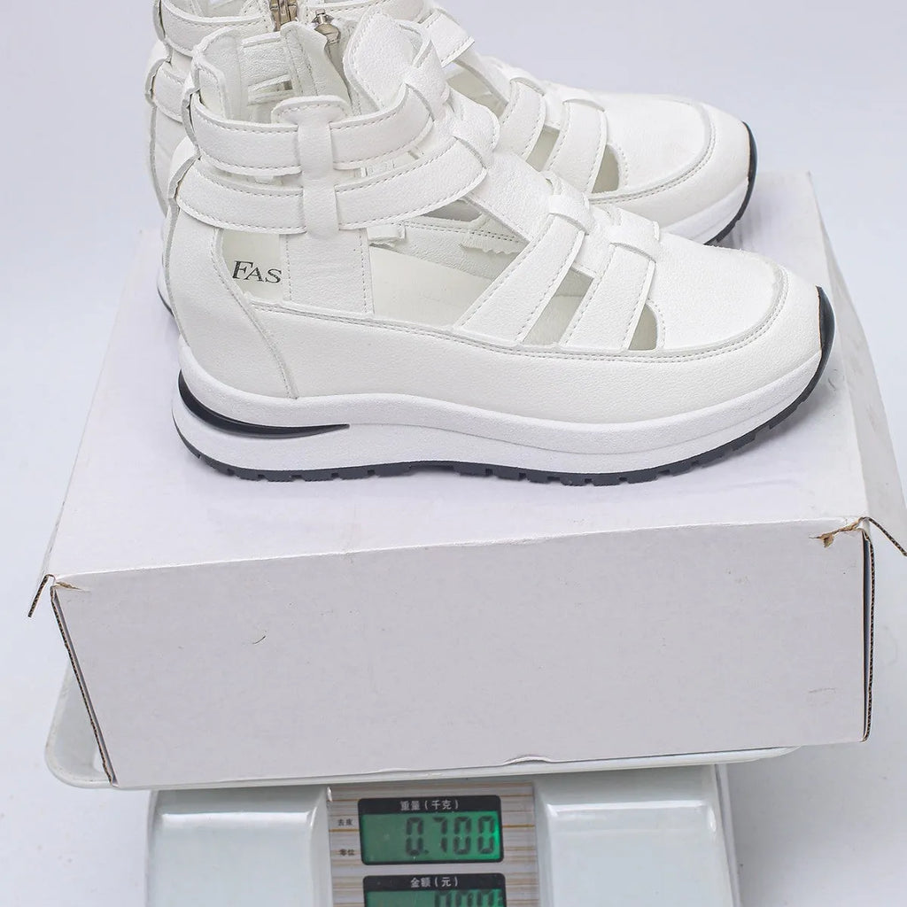 Black women's close-toed hollow-out platform sandals with Velcro strap on a white background