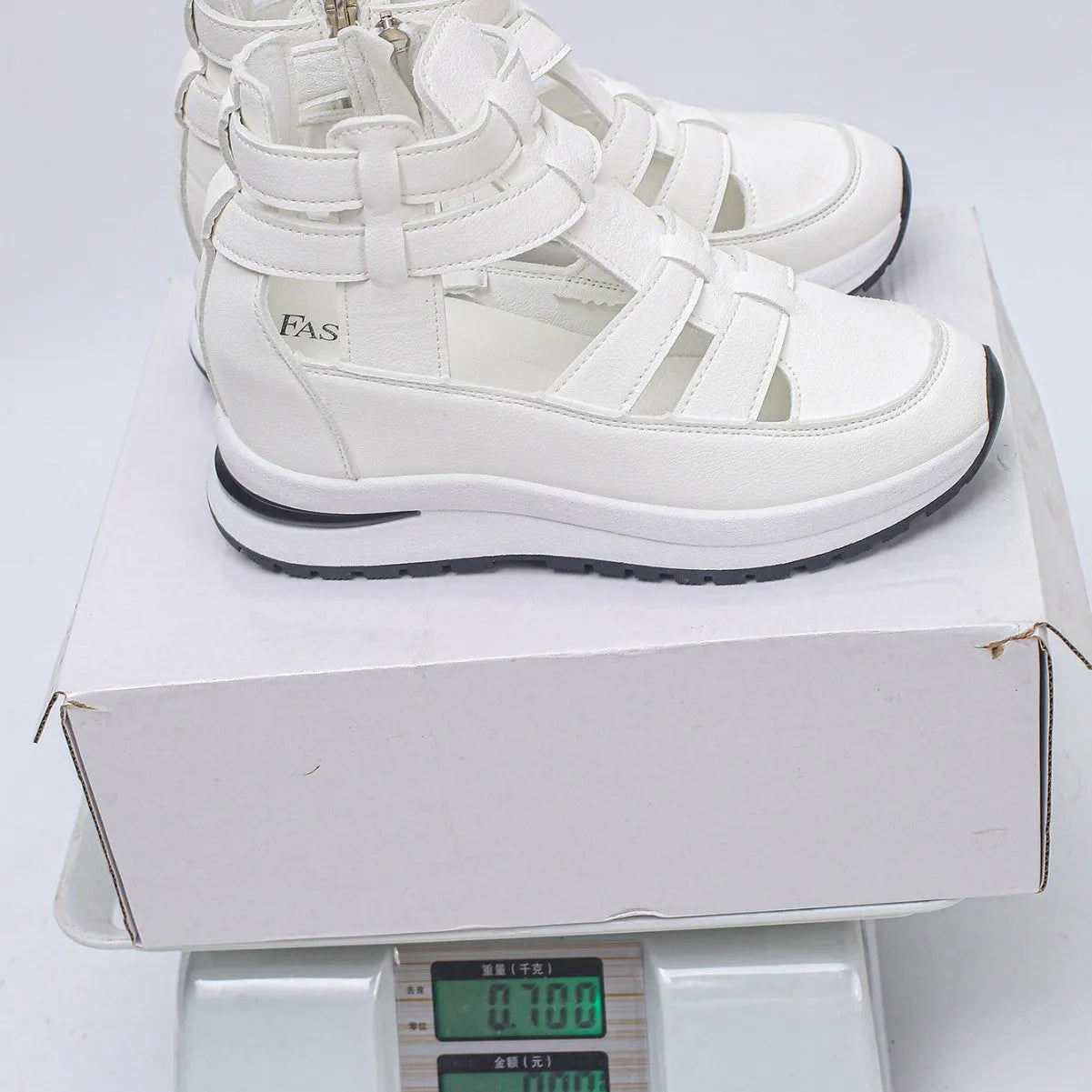 Black women's close-toed hollow-out platform sandals with Velcro strap on a white background