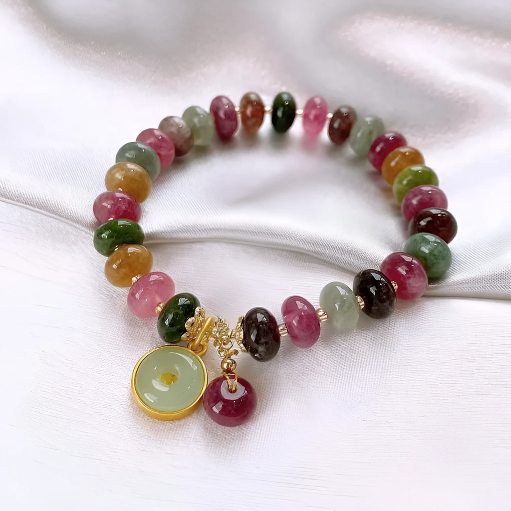Colourful tourmaline abacus bead bracelet with rabbit pendant charm on wrist