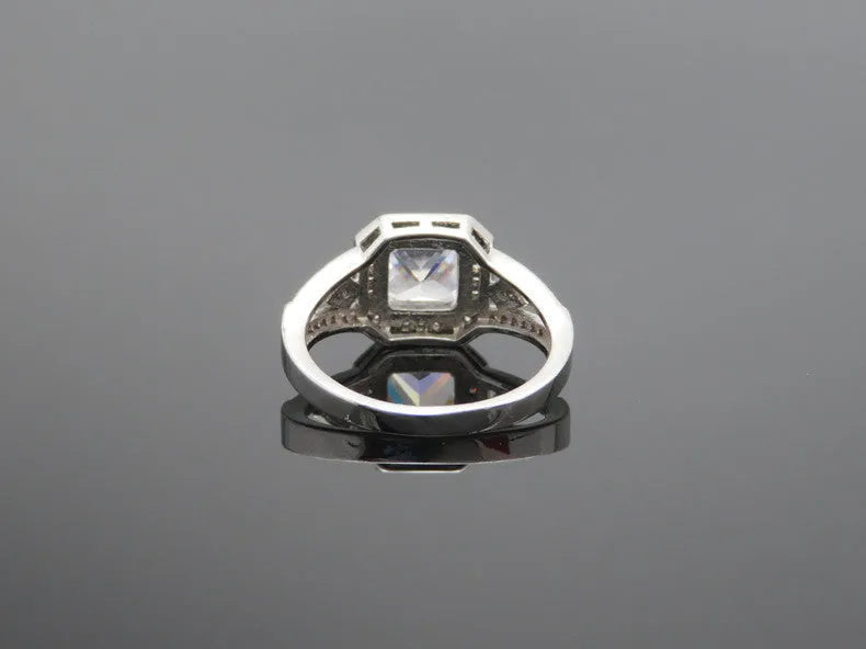 Platinum colour geometric women's ring with hollow design and inlaid zircon stone.