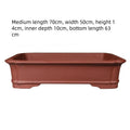 Rectangular handmade purple clay flowerpot showing thickened ceramic walls and substantial planting dimensions