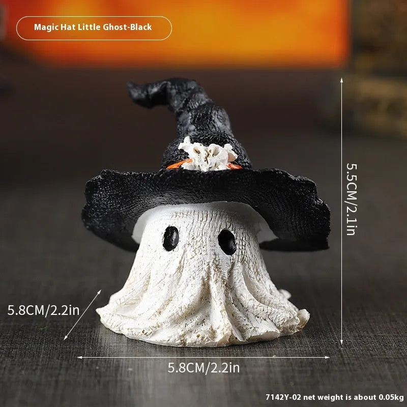 Close-up of a detailed black and a purple resin wizard hat ornament for holiday decoration.