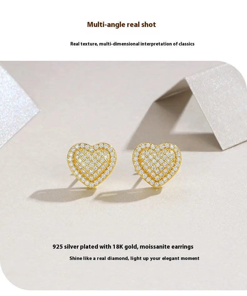 Golden heart-shaped stud earrings with moissanite stones on silver posts