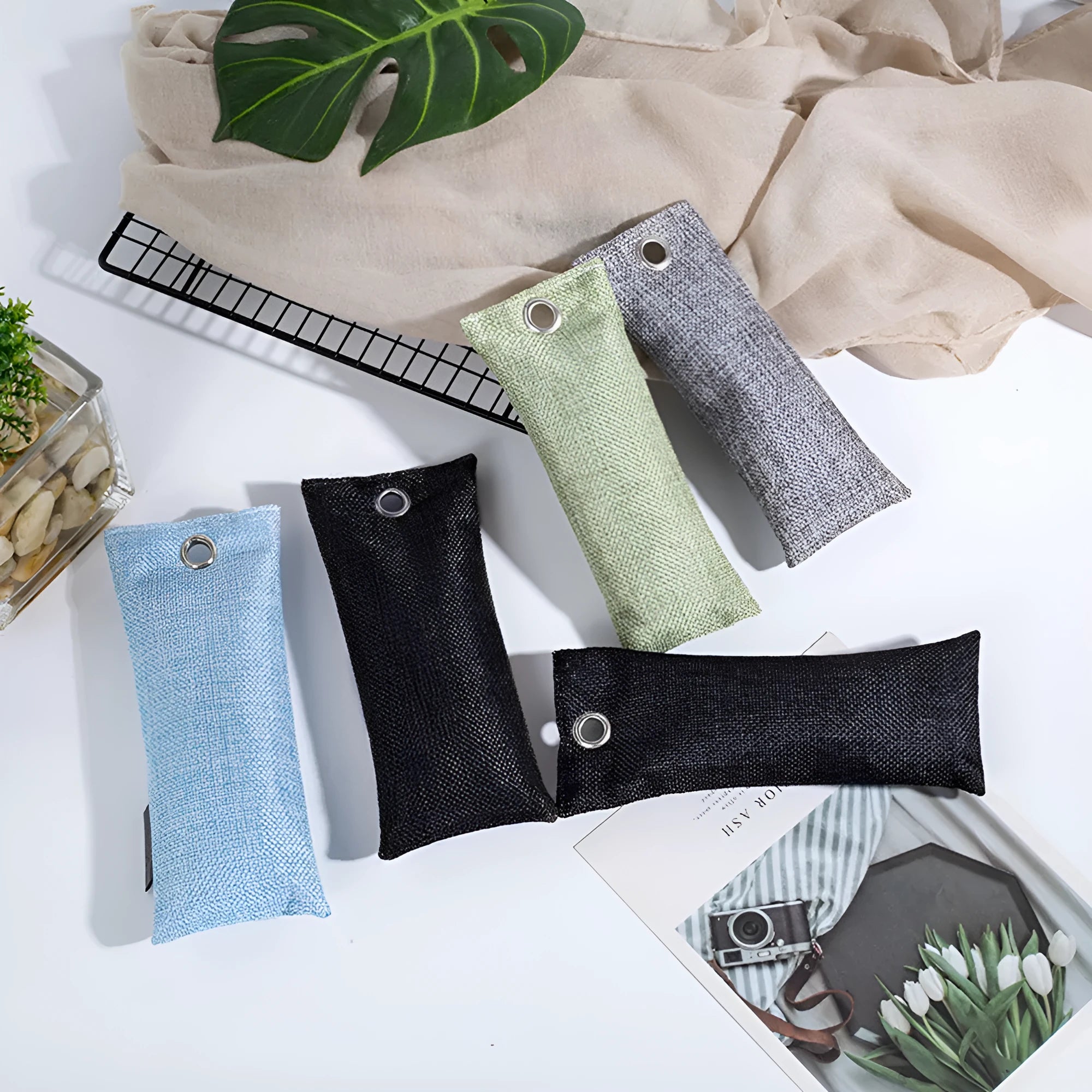 Black, green, grey, and blue bamboo charcoal deodoriser bags for shoes and household odour absorption.