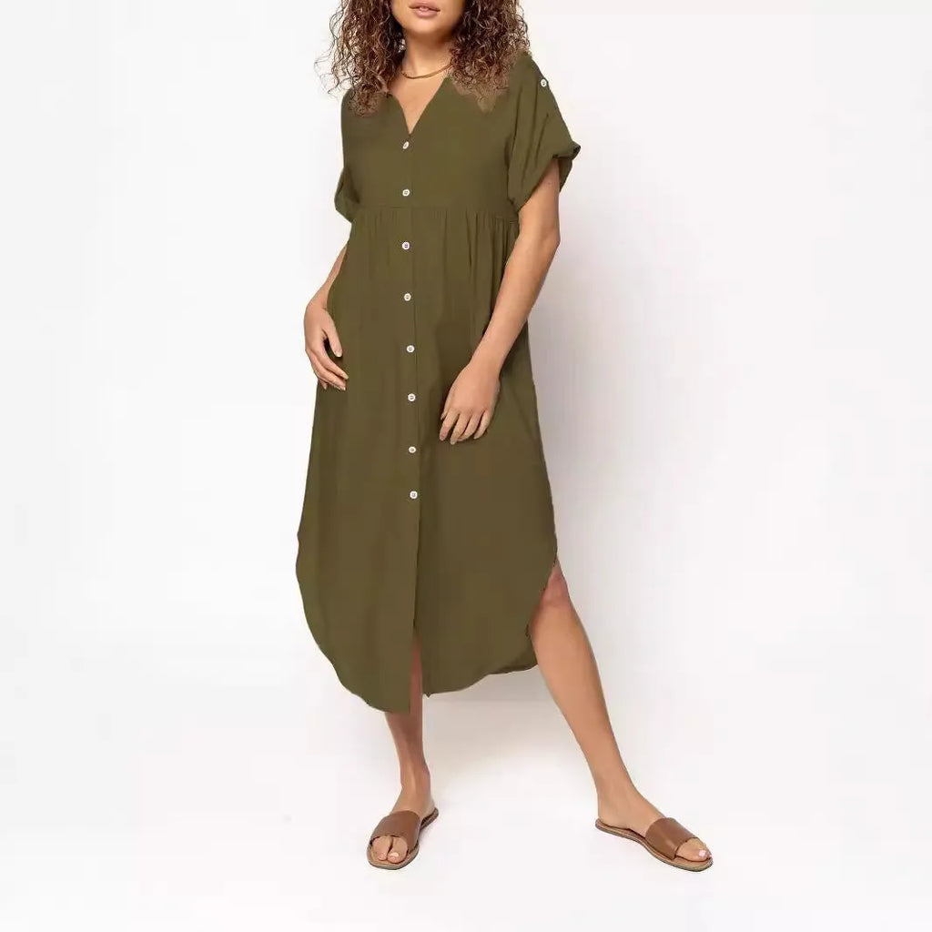 A woman wearing a loose-fitting, solid-colour midi dress with a button-down front and regular sleeves.