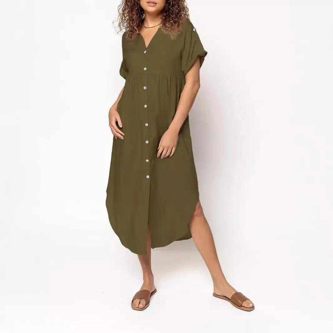 A woman wearing a loose-fitting, solid-colour midi dress with a button-down front and regular sleeves.
