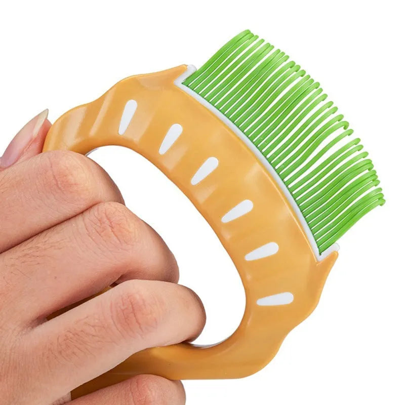 Green shell-shaped pet grooming brush with fine wire bristles on a white background.