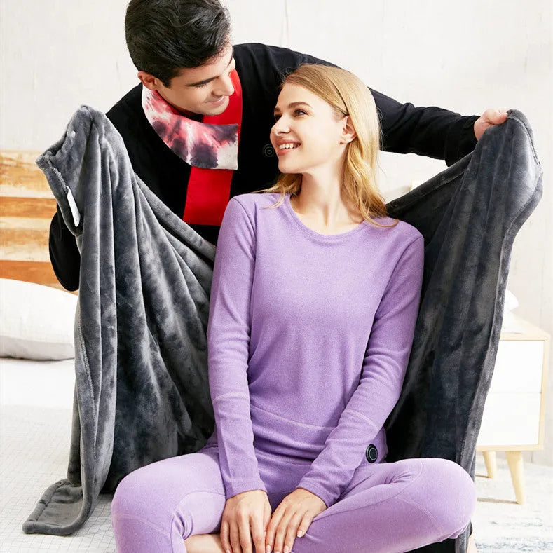 Dark grey USB-powered coral fleece electric heated blanket showing control button and cable.