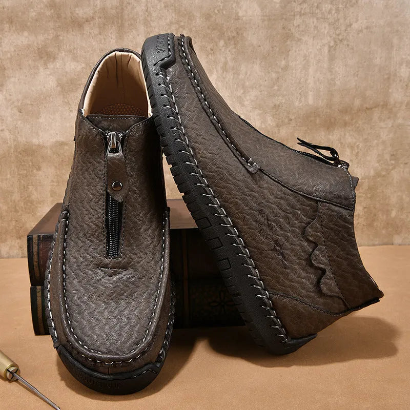 Men's black slip-on leather loafers with a round toe and low flat heel on a rubber sole.