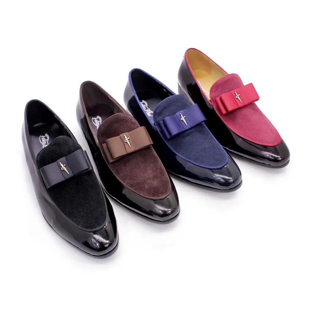 Men's glossy black patent leather low-top shoes featuring a gold tassel detail on a white background.