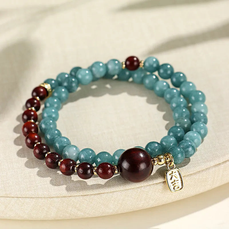Close-up of a blue electroplated women's beaded bracelet with geometric and Fu/Xi character charms in New Chinese style.