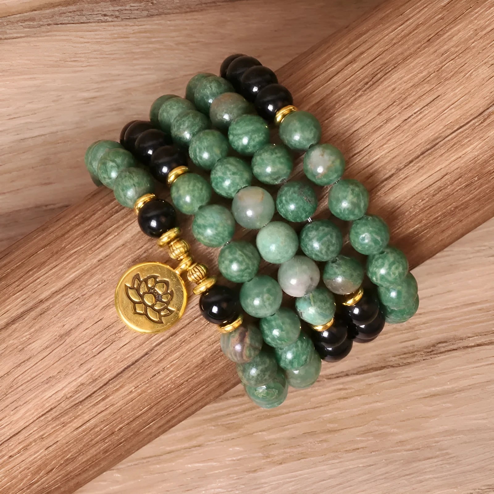 Long elastic bracelet with green and black alloy charms and natural style beads on a stretch band.