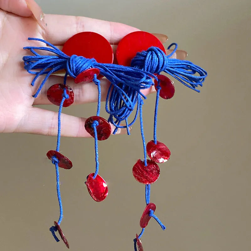 Geometric-shaped cloth earrings in silver needle and blue resin flower colours.