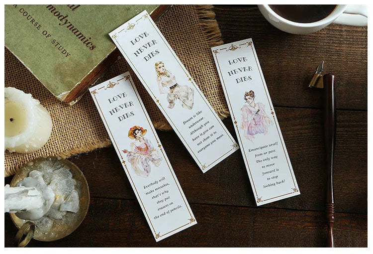 Pack of 30 white cardboard art bookmarks with designs including flowers and patterns, next to their plastic carton.