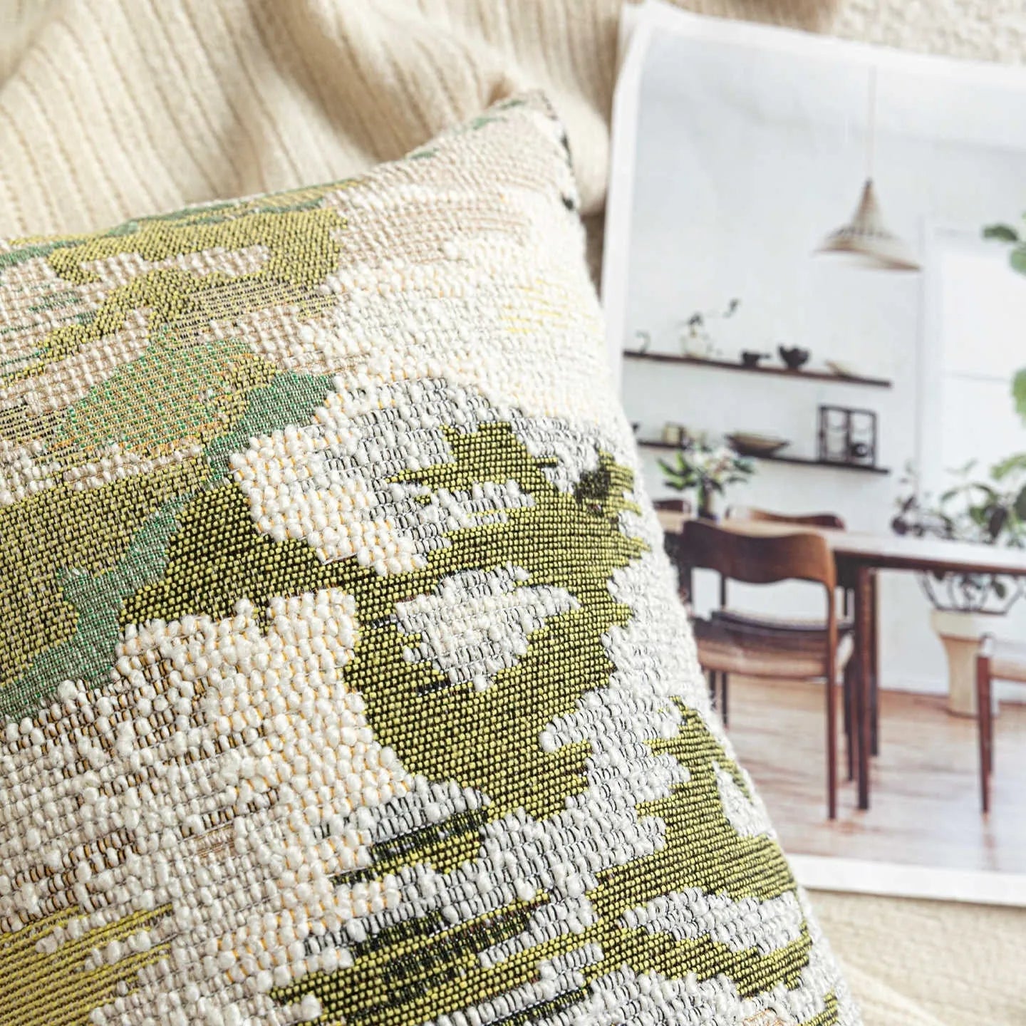 Antique green wool blend cushion with abstract spring flower botanical pattern.