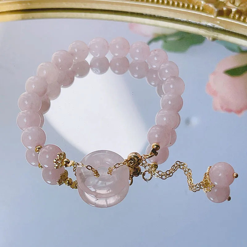 Pink crystal peace buckle bracelet with safety clasp on silver-coloured chain