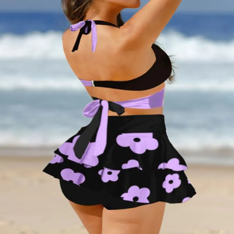 Black high-waist women's bikini with lace-up back and matching swim skirt laid flat.