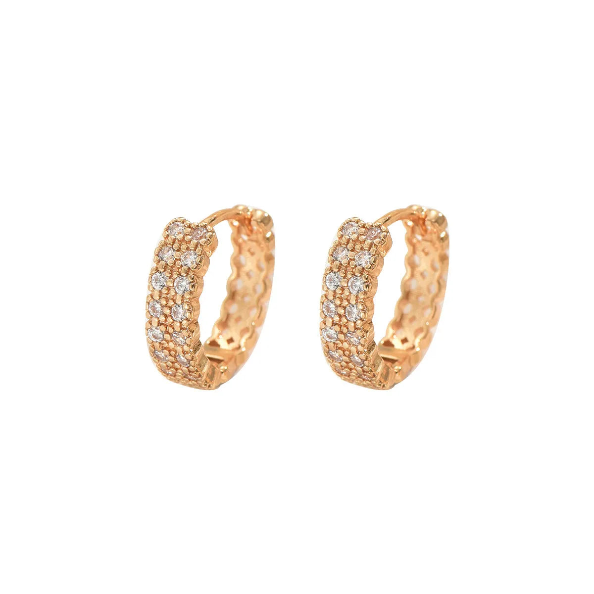 A pair of geometric pattern copper ear studs with round, dot, and ring decorative details.