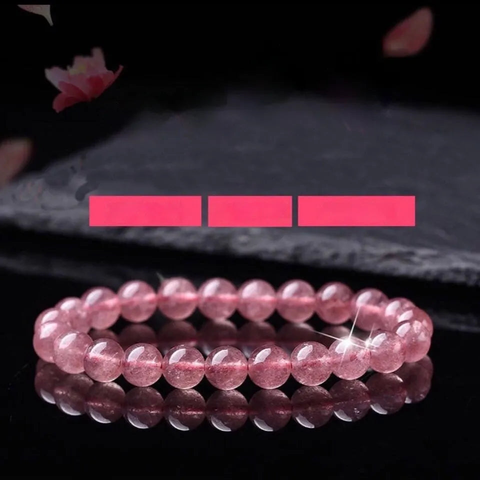 Women's strawberry quartz crystal bracelet with polished beads in three size options on wrist