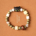 Hand-woven beaded bracelet with a cat's paw charm, jade, and wood beads in a cartoon style.