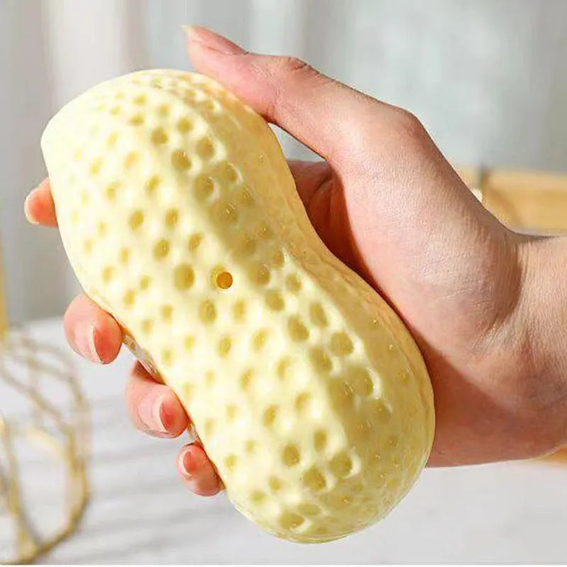 Yellow peanut-shaped dog chew toy with squeaker for dental cleaning