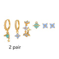 Gold and silver flower shaped stud earrings with a central zircon stone, showing front and back.
