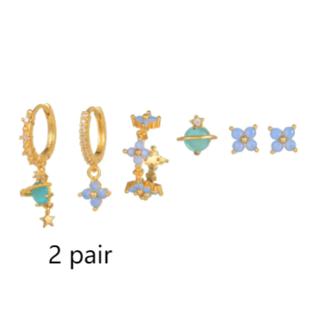 Gold and silver flower shaped stud earrings with a central zircon stone, showing front and back.