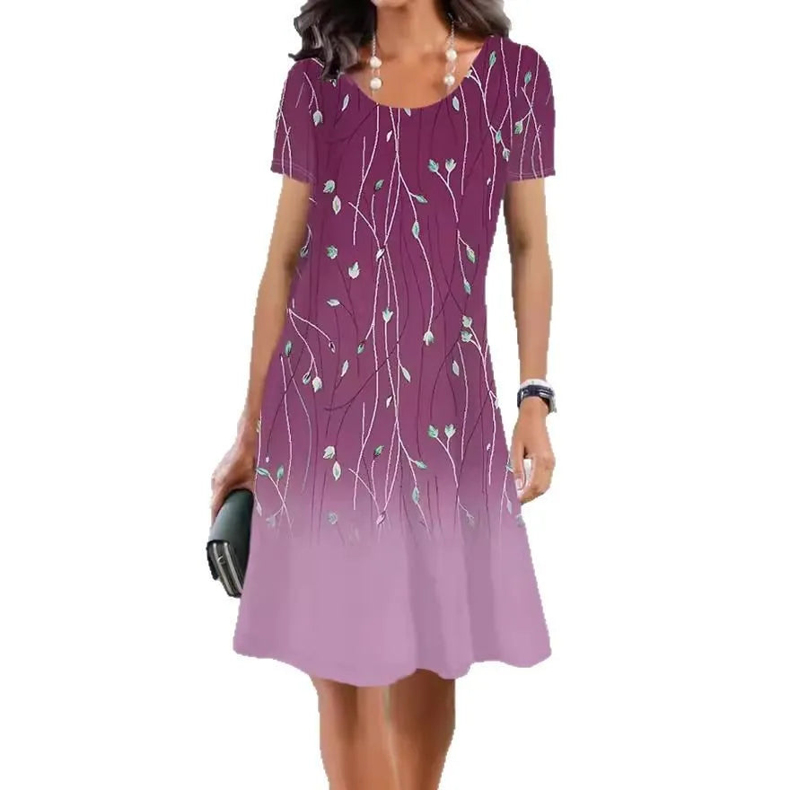 Women's mid-length summer dress with a floral print on light fabric, showing short sleeves and an A-line skirt.
