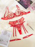 Women's embroidered see-through cutout lingerie set with garters in sapphire blue