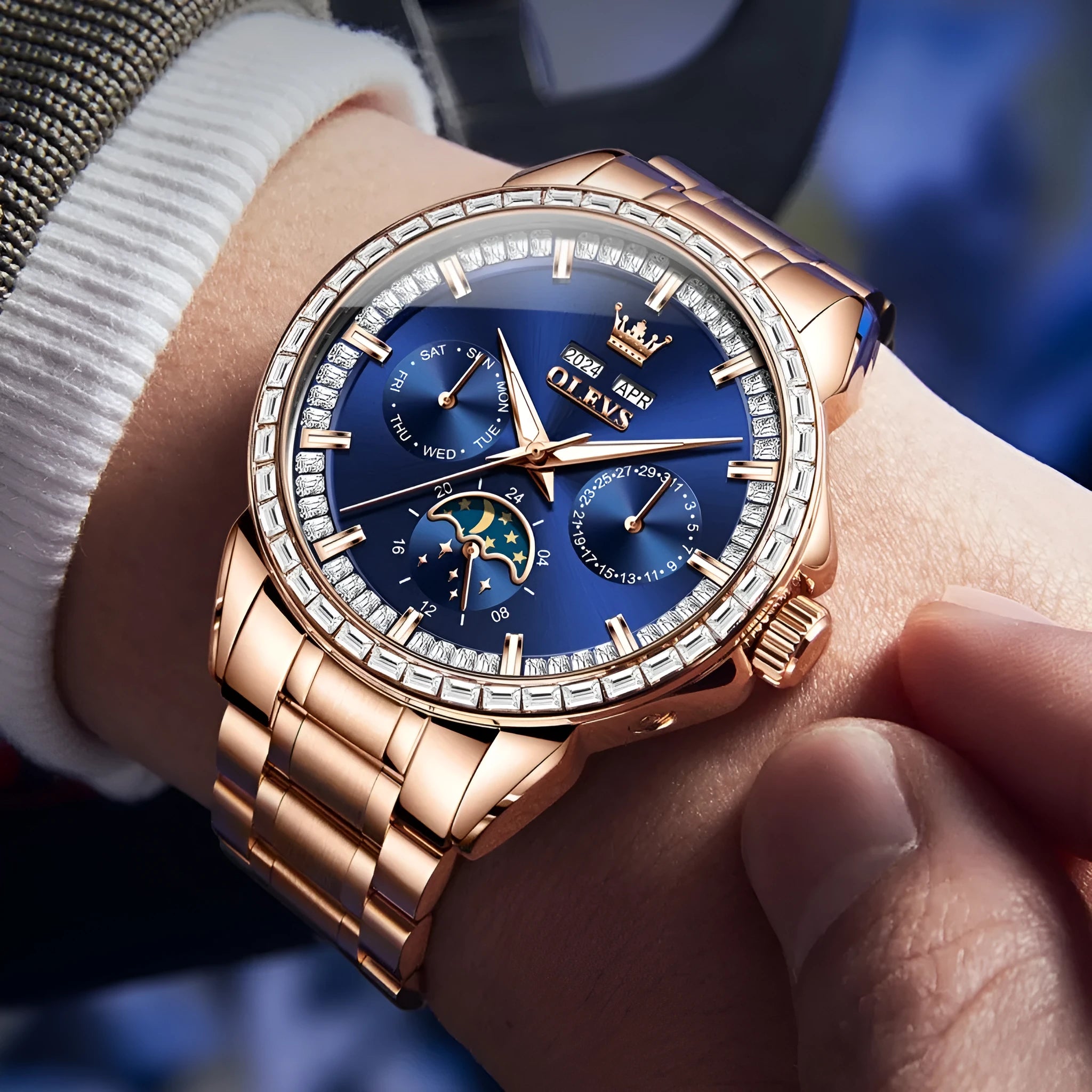 Men's automatic watch with diamond bezel and stainless steel bracelet on wrist, showing skeleton caseback.