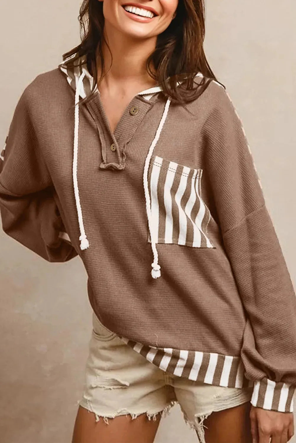 Straw yellow waffle texture hoodie with striped patchwork and a button neck.