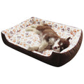 Beige plush sofa-style dog bed mat with raised sides for a small dog, shown next to size chart.