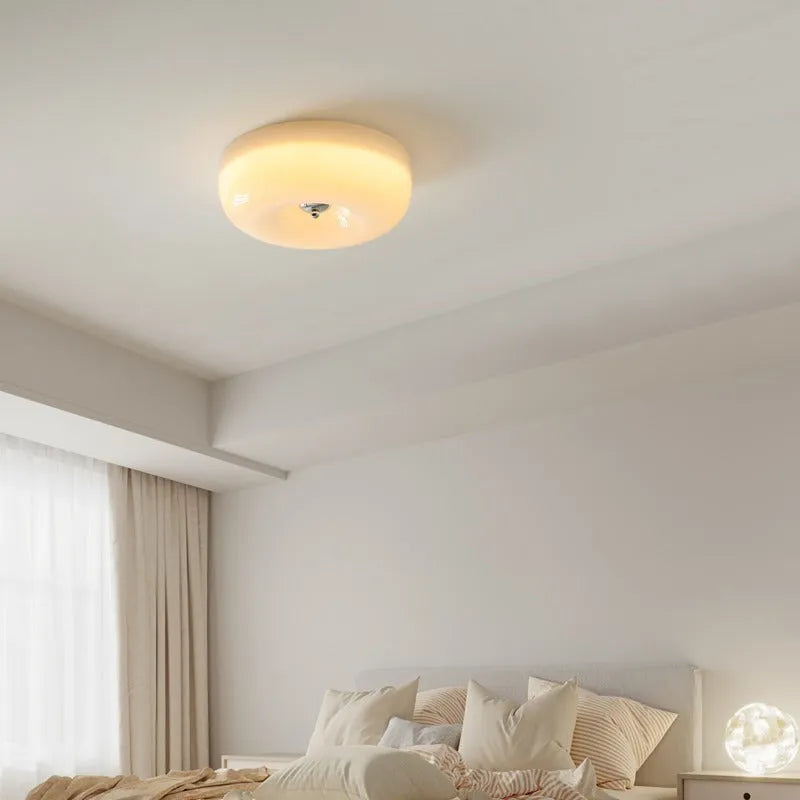 American style cream coloured bedroom ceiling lamp with three-colour light fitting on a white ceiling.