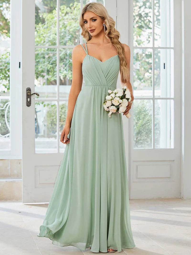 Women's sleeveless long dress with pleated detail and an A-line skirt in a light green colour.