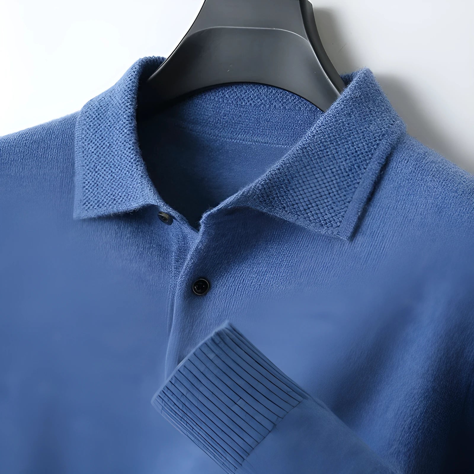 Men's polo collar wool sweater in noble blue colour showing long sleeves and knit texture