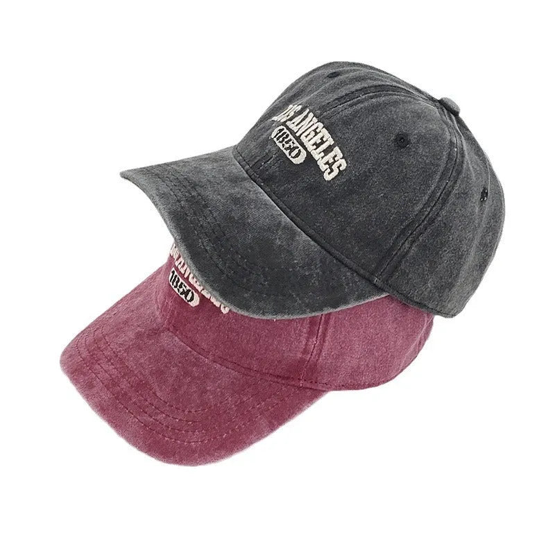 Retro personalised distressed peaked cap with embroidered letters, shown on adjustable strap, in navy blue colour.