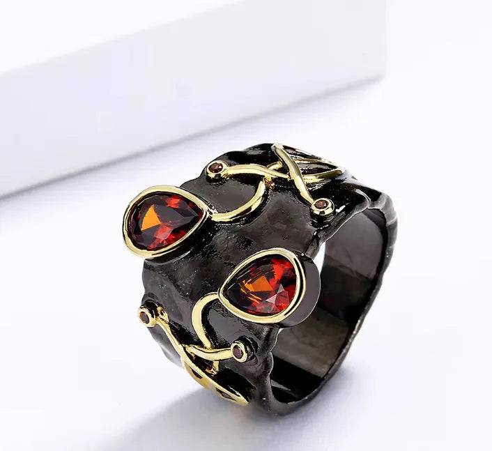 Retro women's brass oval ring in black finish on white background
