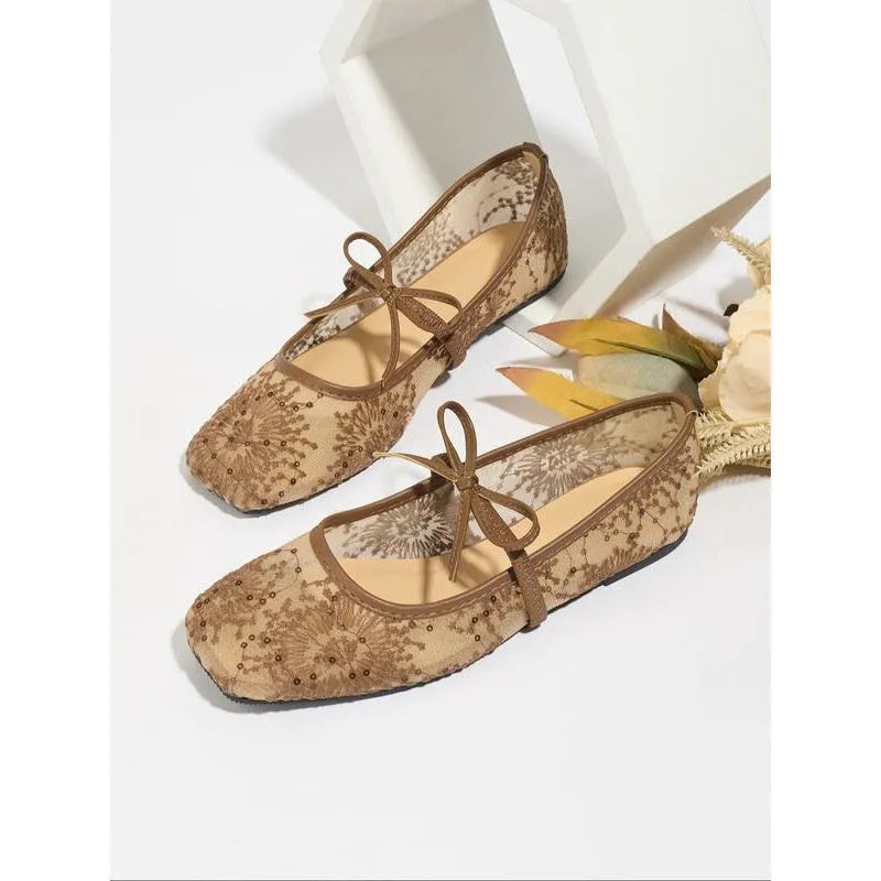 Women's pink flat lace mesh Mary Jane evening shoes with a mid heel on a white background.