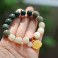 Women's handwoven bracelet with gradient White Jade beads and beeswax Lotus pendant on Bodhi root