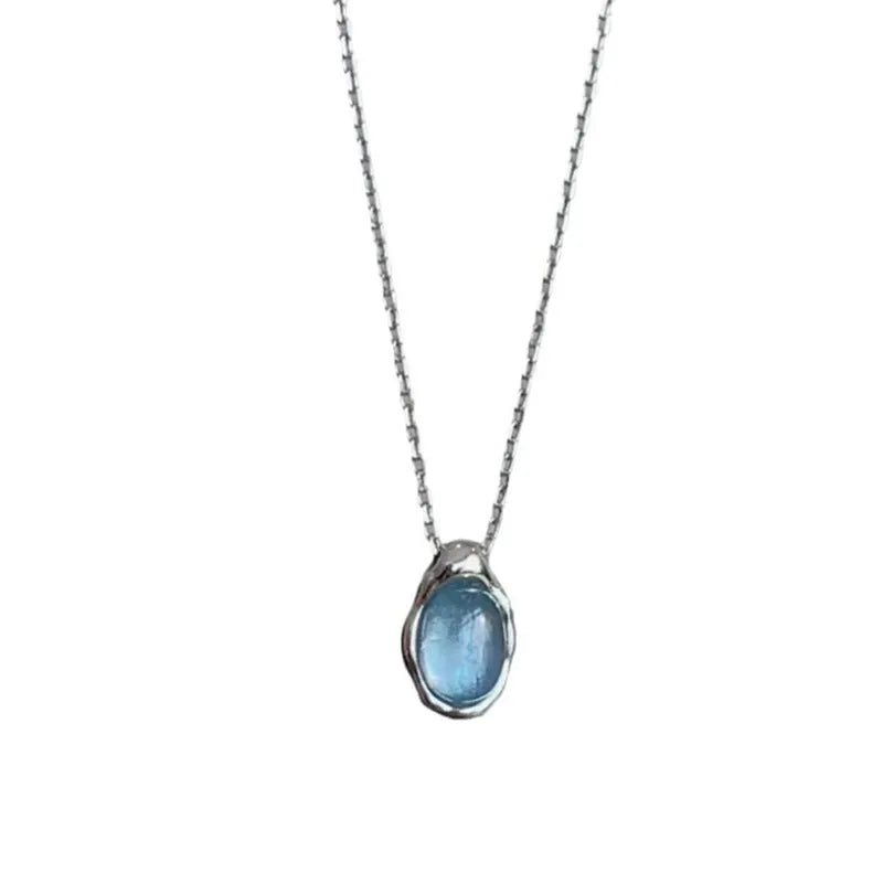 A women's navy blue geometric water drop pendant necklace with a platinum-colour finish on an adjustable cross chain.