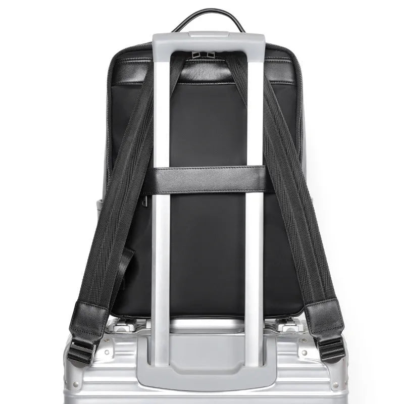 Black genuine leather men's laptop backpack with woven details and adjustable straps.