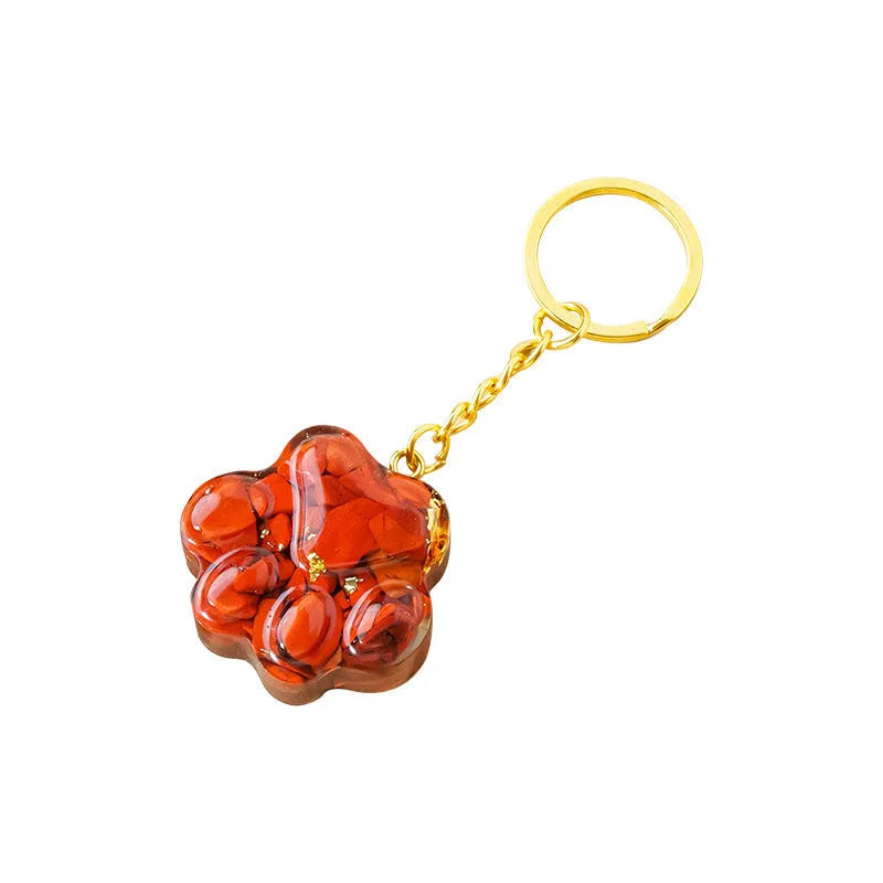Small natural crystal cat's paw shaped keychain pendant on a keyring.